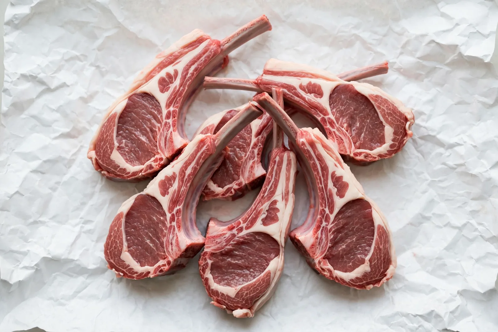 Fresh raw kosher lamb chops on white butcher paper — Satmar Meats Brooklyn